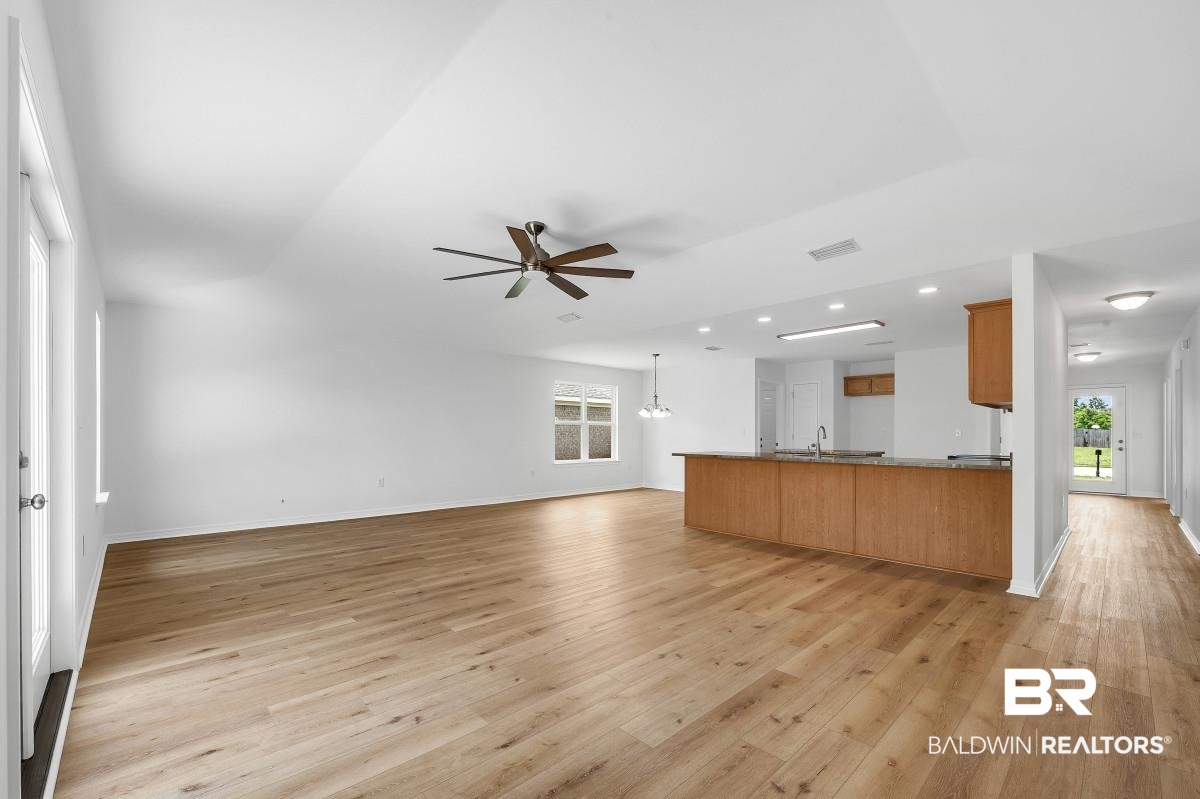 16927 Sugar Loop Foley, AL 36535 - Photo 4 of 50 Unfurnished living room featuring a ceiling fan, light wood-style flooring, healthy amount of natural light, and recessed lighting