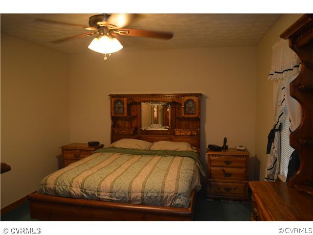 15713 Saddlebrook Road Chesterfield, VA 23838 - Photo 13 of 19 a bedroom with a bed and a chandelier