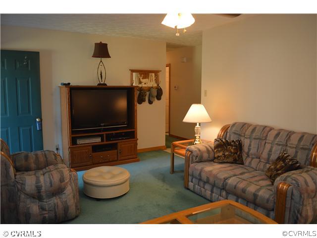 15713 Saddlebrook Road Chesterfield, VA 23838 - Photo 6 of 19 a living room with furniture and a flat screen tv