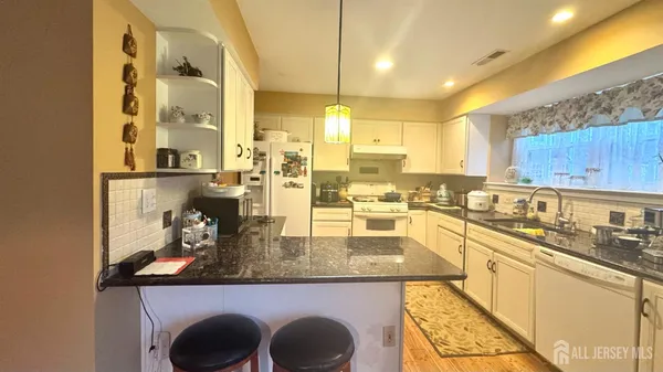 a kitchen with a sink a stove and refrigerator