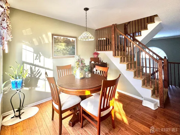 a dining room with furniture a chandelier and wooden floor