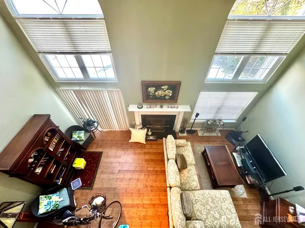 a living room with furniture a rug and a fireplace
