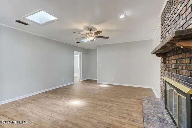 wooden floor in an empty room with a window
