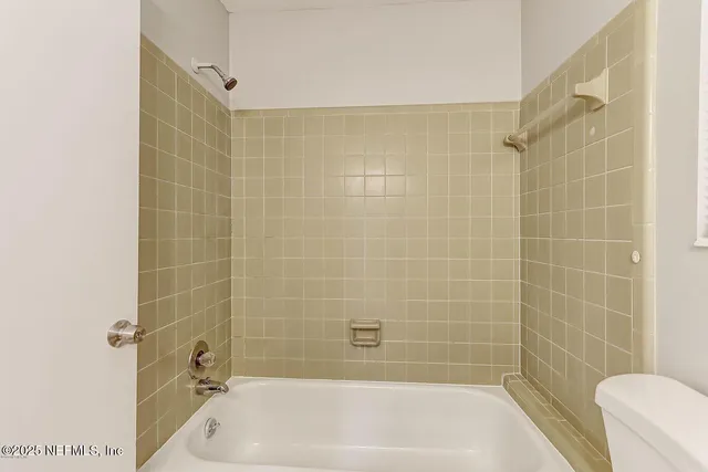 a bathroom with a shower and a bathtub