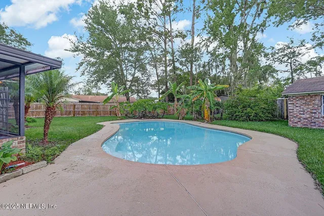 a view of a swimming pool with a yard