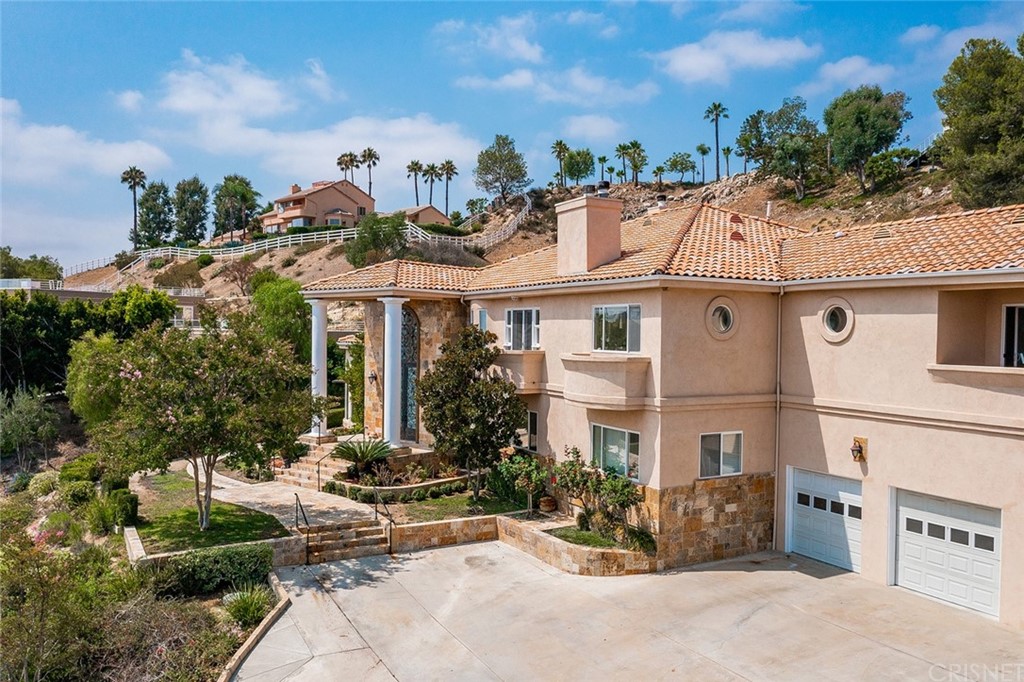 163 Dapplegray Road Bell Canyon, CA 91307 - Photo 2 of 7 a view of a building with potted plants and a bench