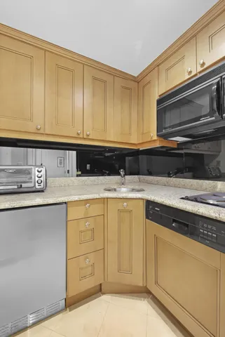 a kitchen with granite countertop cabinets stainless steel appliances and a sink