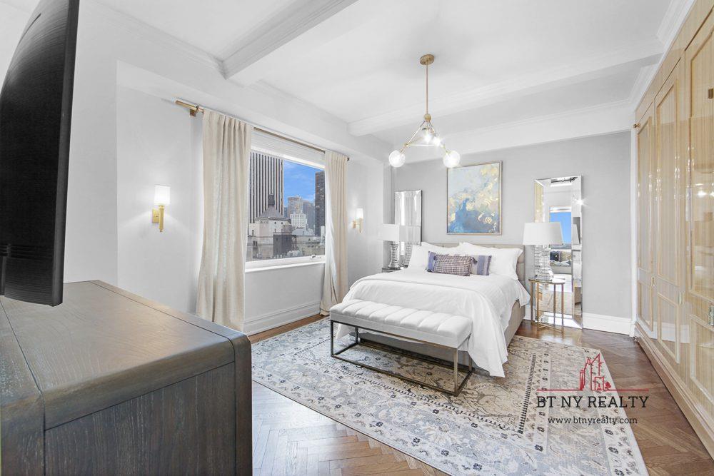 160 Central Park South, Unit 2118/2120 Manhattan, NY 10019 - Photo 5 of 16 a spacious bedroom with a bed and a window