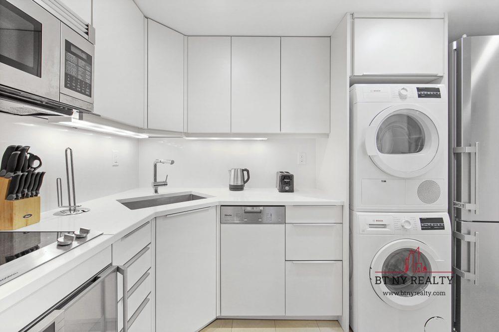 160 Central Park South, Unit 2118/2120 Manhattan, NY 10019 - Photo 7 of 16 a kitchen with stainless steel appliances granite countertop a sink a stove and cabinets