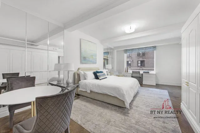 a bedroom with a bed a table and chair