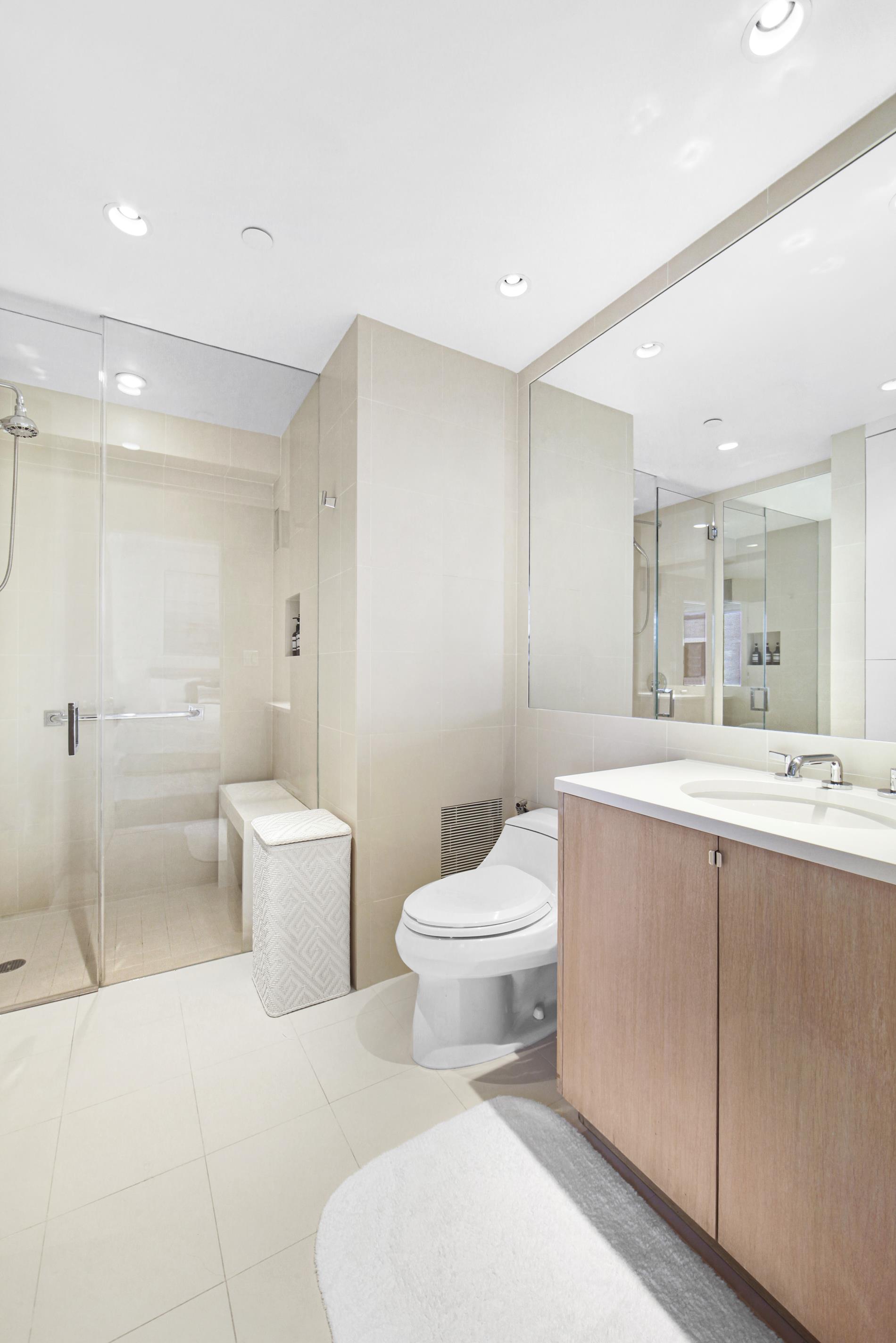 160 Central Park South, Unit 2118/2120 Manhattan, NY 10019 - Photo 9 of 16 a bathroom with a sink a toilet and shower