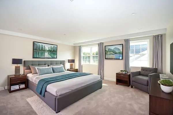 a bedroom with bed couch and window