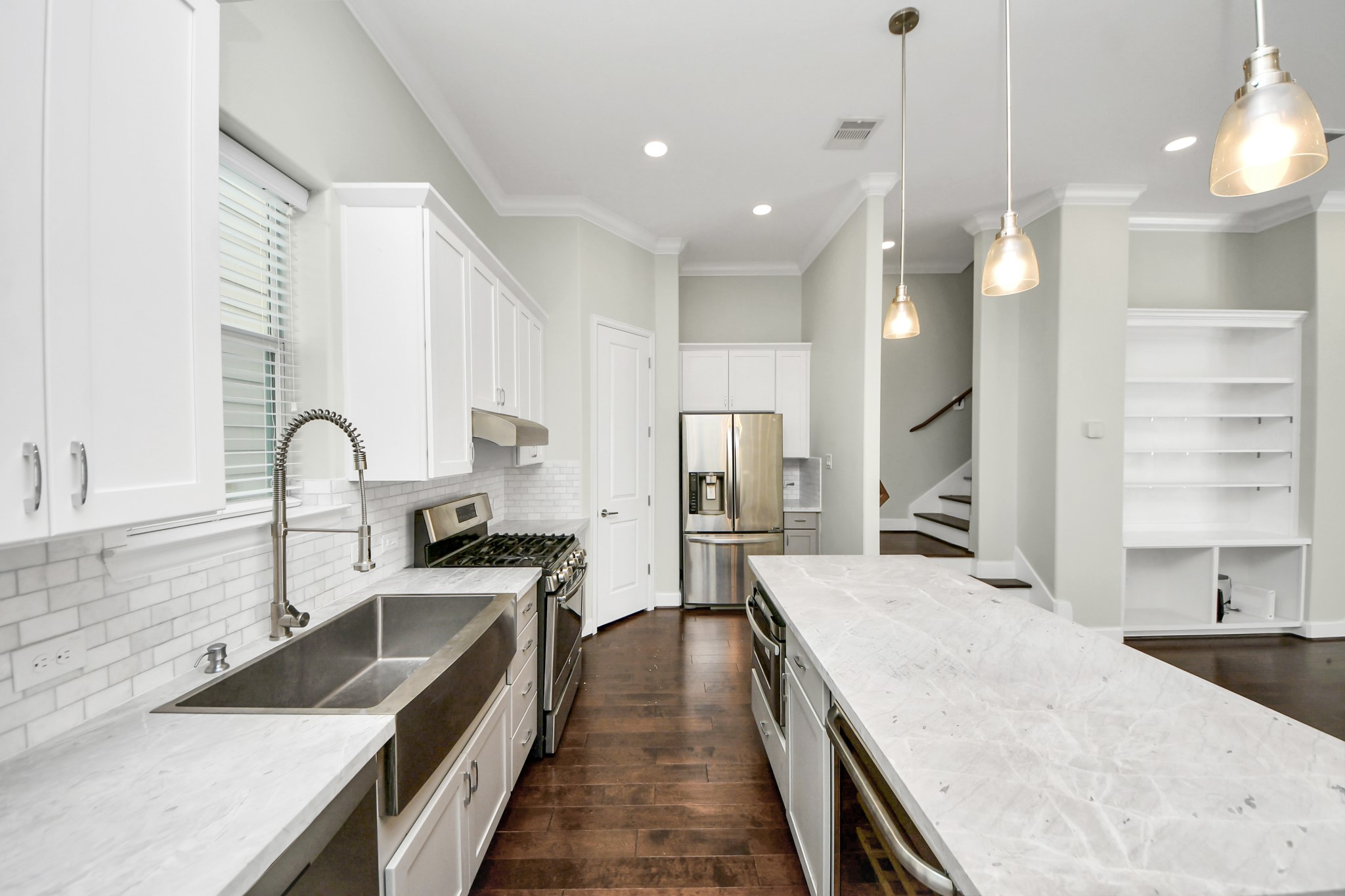 1716 Stuart Street Houston, TX 77004 - Photo 21 of 39 a view of a kitchen with kitchen island a sink stainless steel appliances and cabinets