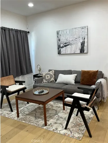 a living room with furniture and a rug