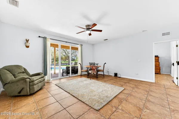 a living room with furniture and large windows