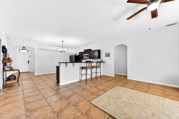 a view of kitchen with furniture and refrigerator