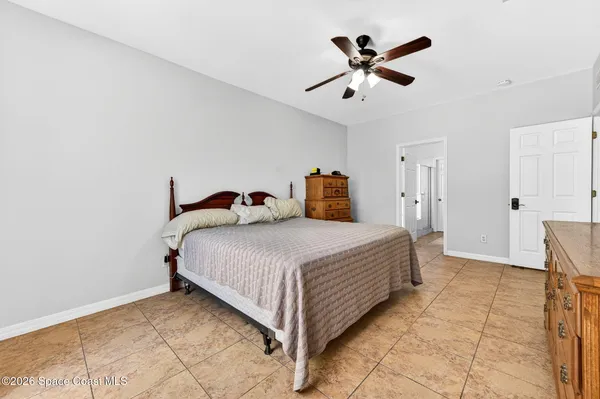 a bedroom with a bed and ceiling fan