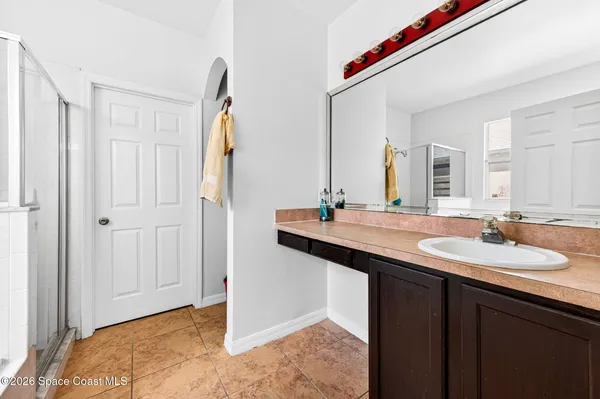 a bathroom with a double vanity sink and a mirror
