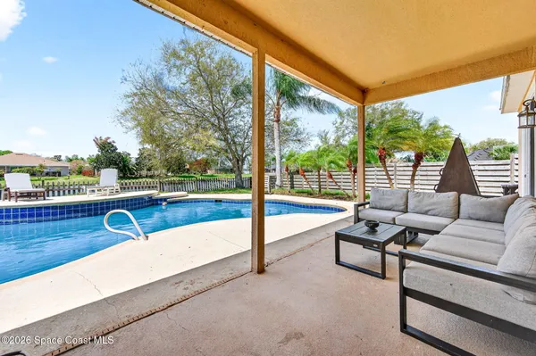 a view of swimming pool with a patio and a yard