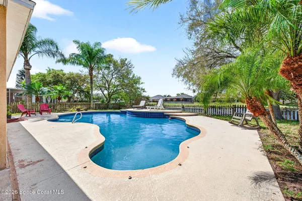 a view of a swimming pool with a patio and a swimming pool