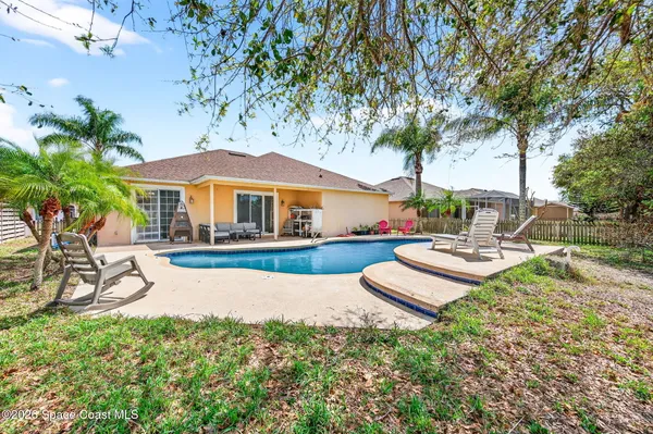 a view of a house with swimming pool and sitting area