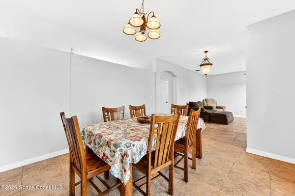 a view of a dining room with furniture and chandelier
