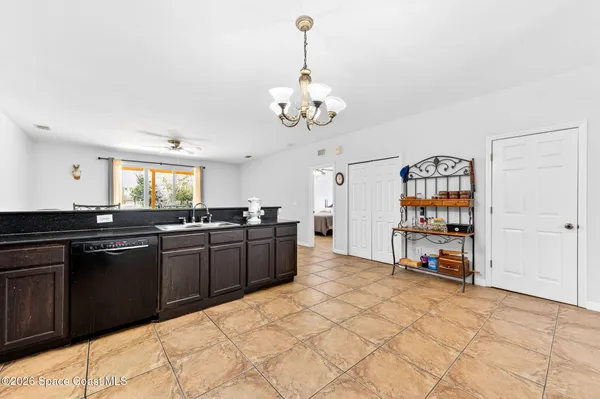 a kitchen with stainless steel appliances granite countertop a stove refrigerator a sink dishwasher with a dining table and chairs