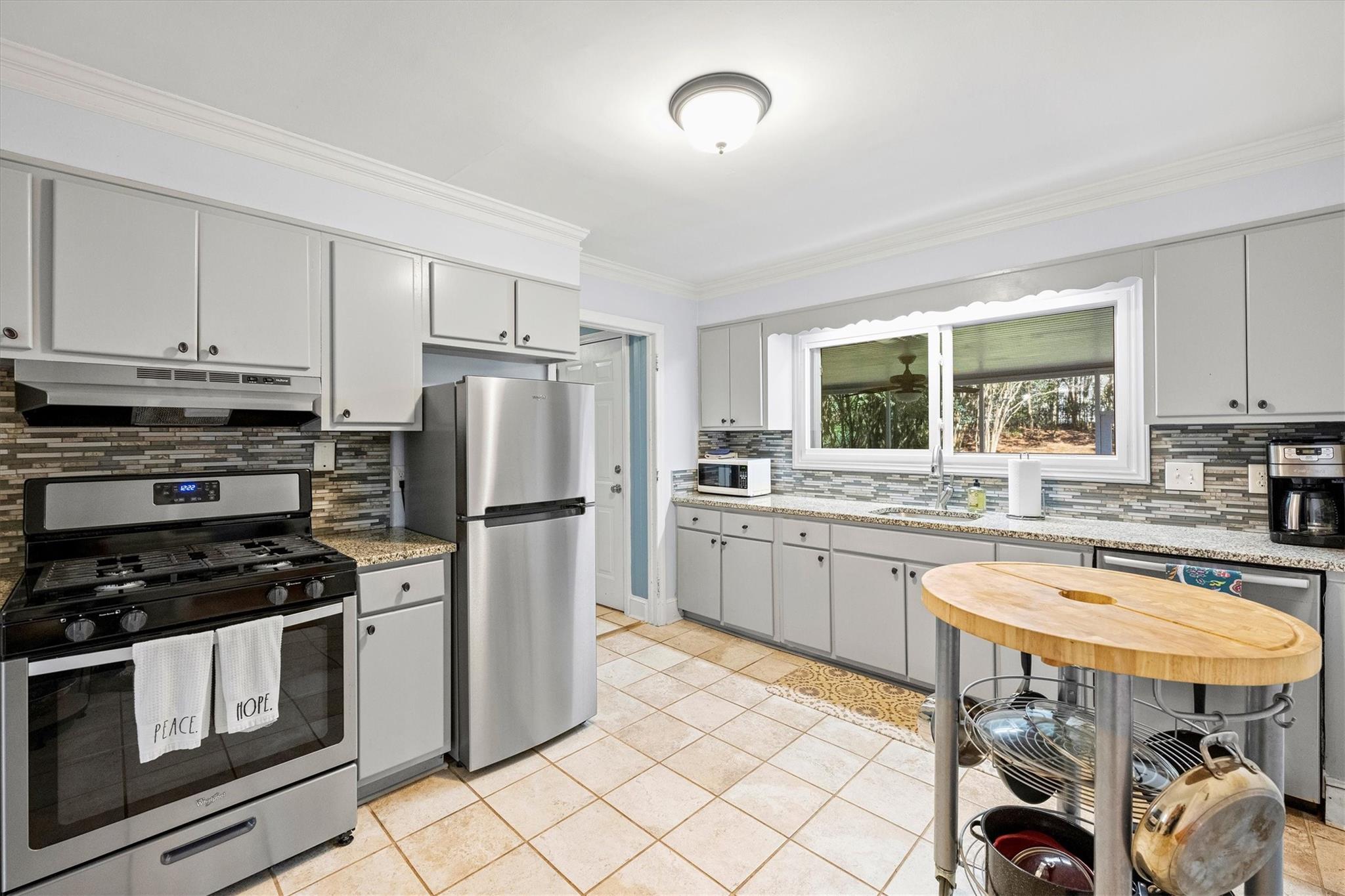 631 Seneca Place Charlotte, NC 28210 - Photo 7 of 21 a kitchen with stainless steel appliances granite countertop a stove refrigerator sink and cabinets
