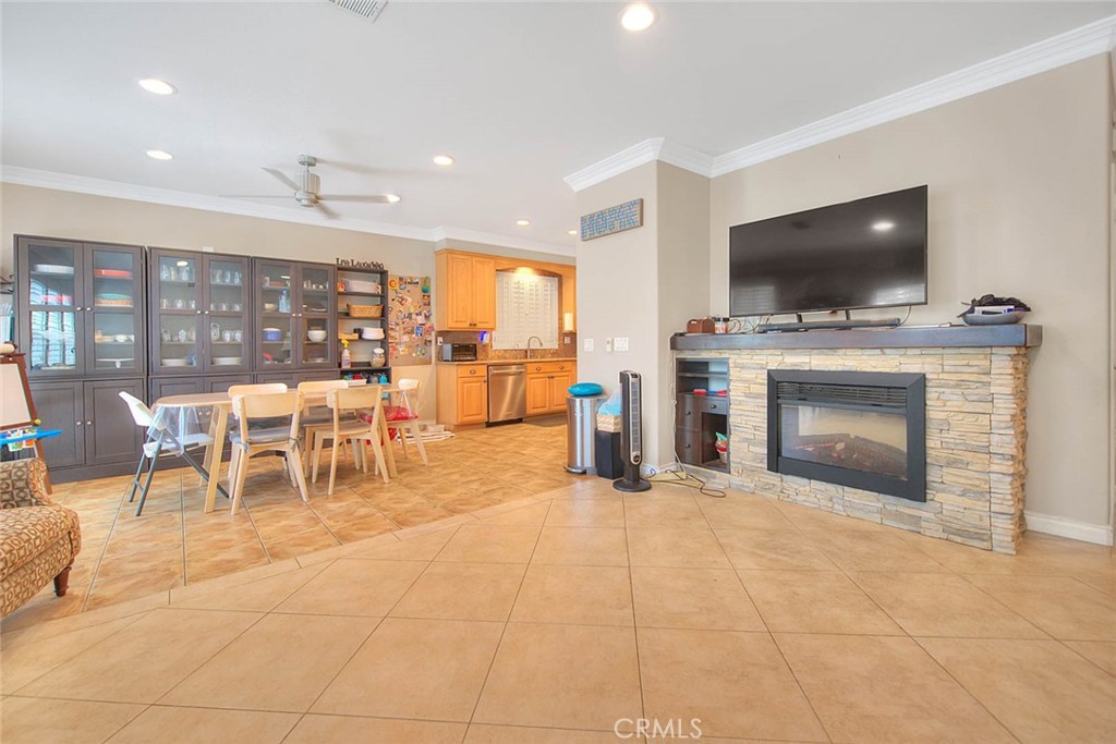 Undisclosed Address Upland, CA 91784 - Photo 14 of 38 a living room with furniture a flat screen tv and a fireplace