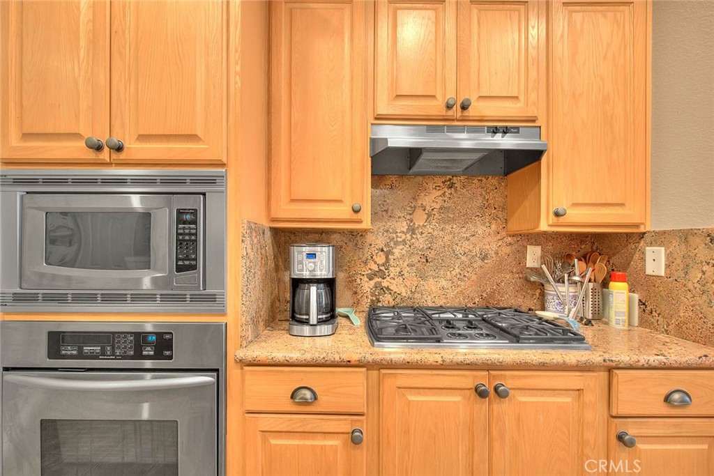 Undisclosed Address Upland, CA 91784 - Photo 16 of 38 a kitchen with granite countertop a stove and a microwave