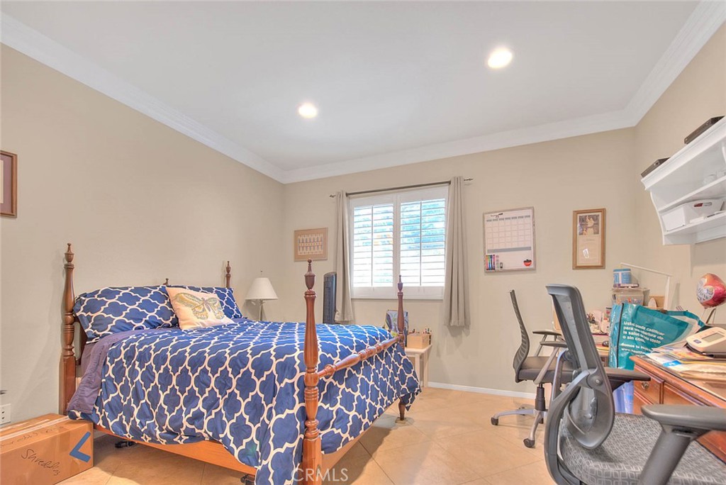 Undisclosed Address Upland, CA 91784 - Photo 17 of 38 a bedroom with a bed a table and chair