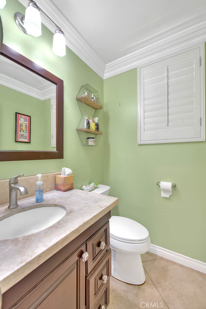 Undisclosed Address Upland, CA 91784 - Photo 18 of 38 a bathroom with a granite countertop toilet sink and mirror