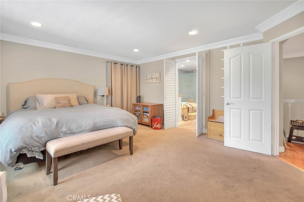 Undisclosed Address Upland, CA 91784 - Photo 32 of 38 a spacious bedroom with a bed and a cabinets
