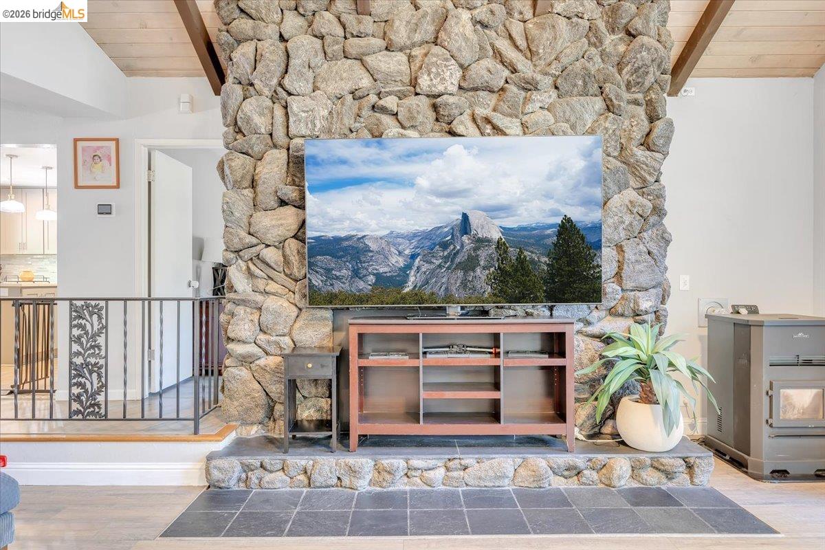8733 Fraguero Road Sonora, CA 95370 - Photo 26 of 73 Floor-to-ceiling stone fireplace featuring an elevated hearth with slate tile flooring