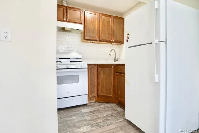 a kitchen with a stove cabinets and a refrigerator