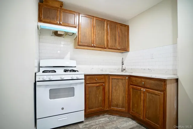 a kitchen with stainless steel appliances granite countertop a sink stove and cabinets
