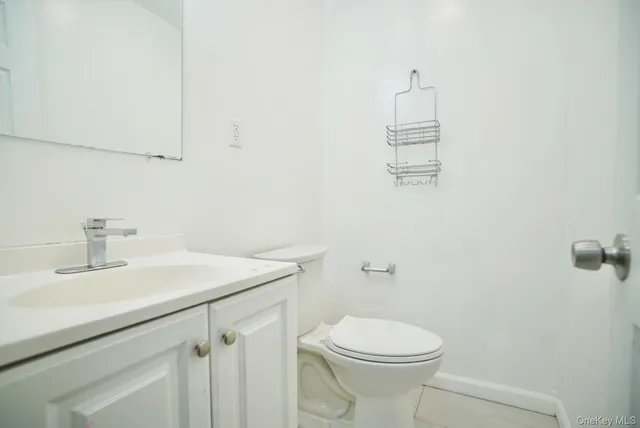 a bathroom with a sink a toilet and mirror