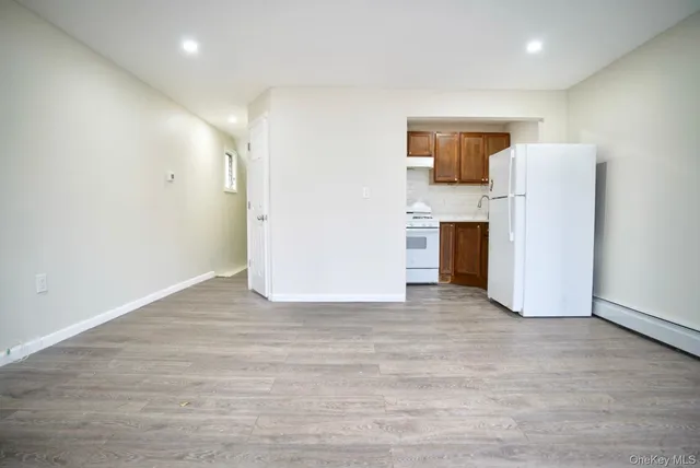 a view of a kitchen with a refrigerator a stove top oven and refrigerator