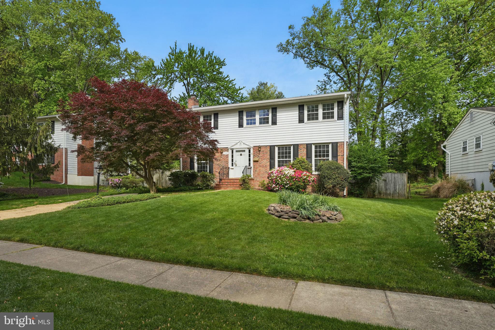 2524 Swift Run Street Vienna, VA 22180 - Photo 1 of 55 a front view of a house with a garden and trees