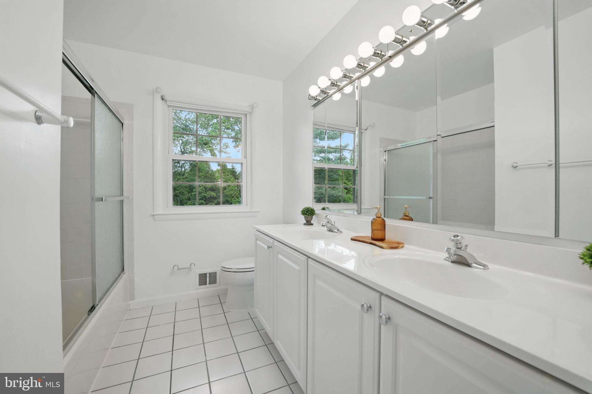 2524 Swift Run Street Vienna, VA 22180 - Photo 21 of 55 a bathroom with a sink a vanity and a mirror