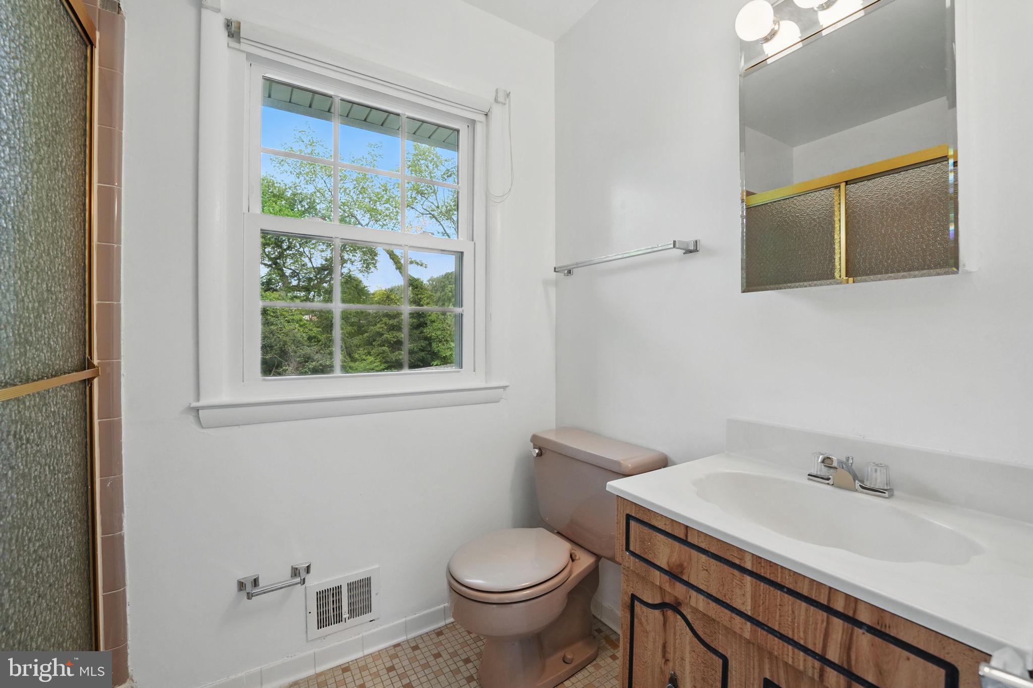 2524 Swift Run Street Vienna, VA 22180 - Photo 25 of 55 a bathroom with a toilet sink and mirror