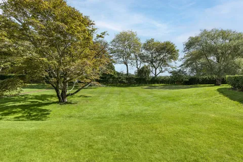 a living room with patio area and garden view