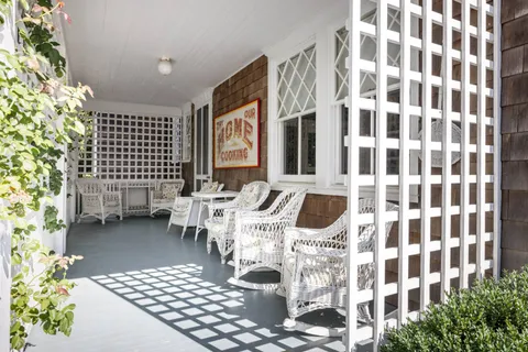 a dining room with wooden floor windows and chairs