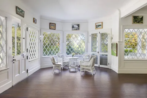 a living room with furniture wooden floor and a large window