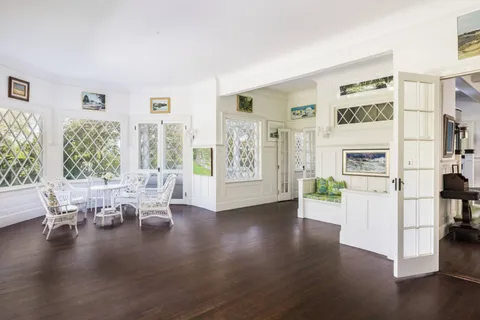 a view of a livingroom with furniture window and wooden floor
