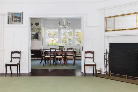 a living room with furniture and a dining table