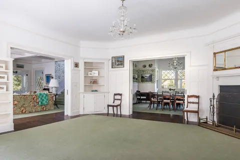 a living room with furniture and a book shelf