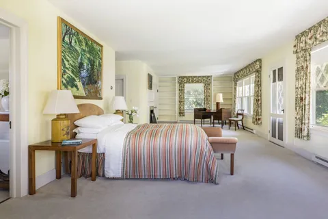 a bedroom with a bed and a fireplace