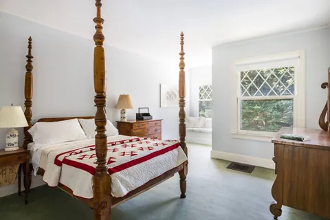 a spacious bedroom with a bed and a window