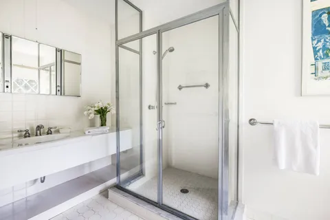 a bedroom with a bed and a table in it with window